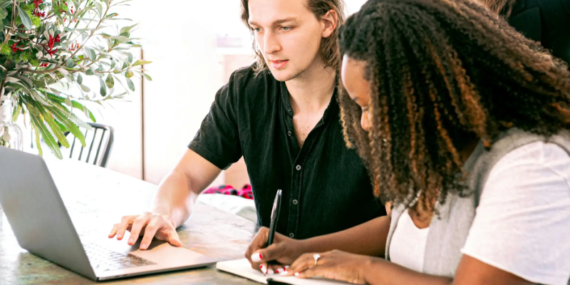 Man and woman working on computer